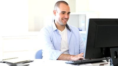 stock-footage-office-worker-typing-report-on-computer